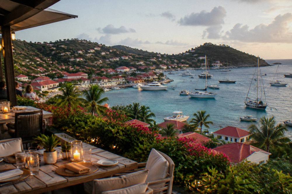 An open-air hotel restaurant terrace at dusk with candles on the tables