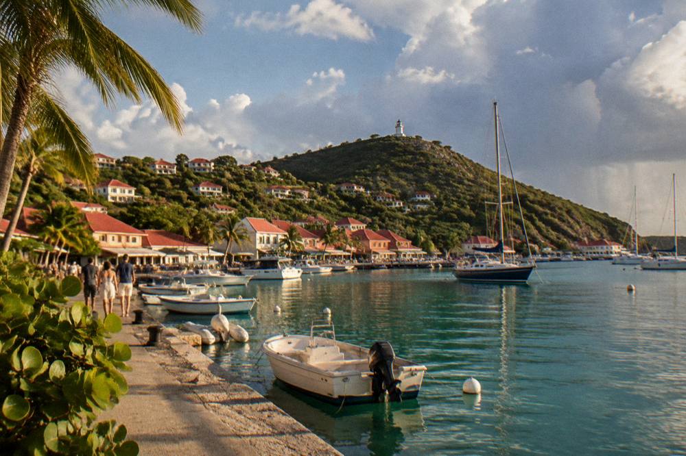 A calm clear evening over a small harbour town with boats at anchor
