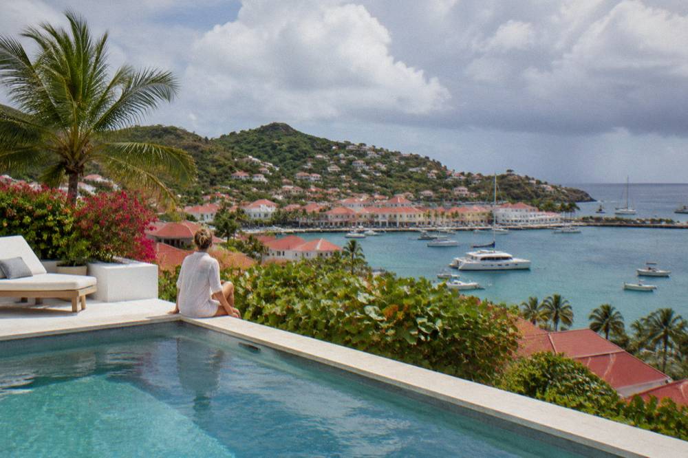 A whitewashed villa terrace with a pool overlooking the sea on St Barts