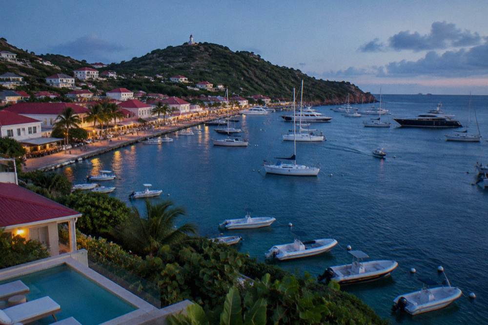 A hillside villa with a pool overlooking the sea