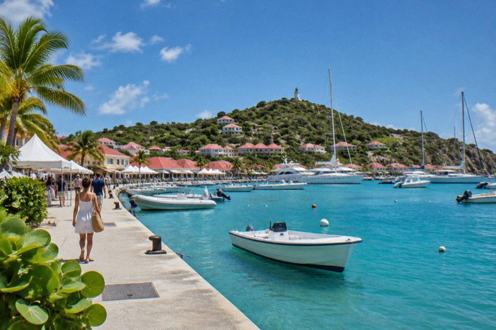 White tents and boats along the quay in Gustavia harbour on a clear day