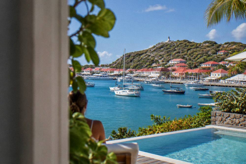 A hillside villa with a pool overlooking the sea at golden hour