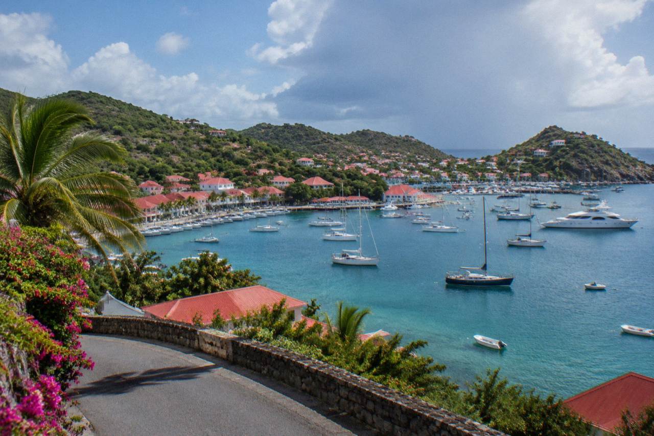 A quiet hillside road above turquoise Caribbean water on St Barts in soft morning light