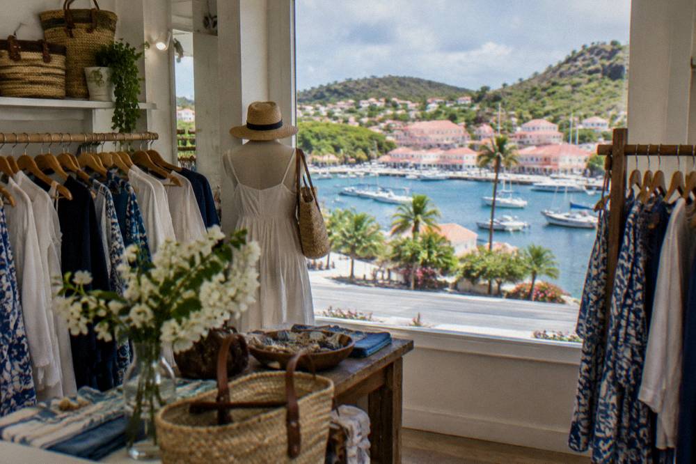 A boutique interior with clothing racks and a French price tag in a harbour town shop