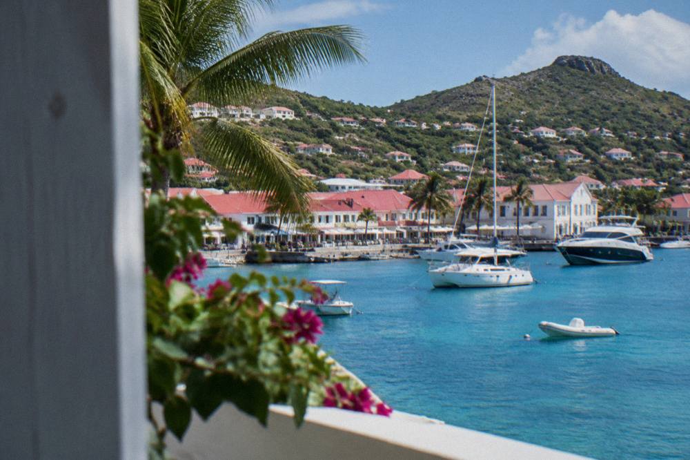 The harbour front of Gustavia with white buildings and moored yachts