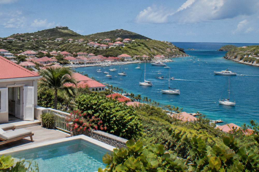 Hillside villa with a private pool overlooking a bay and green headland