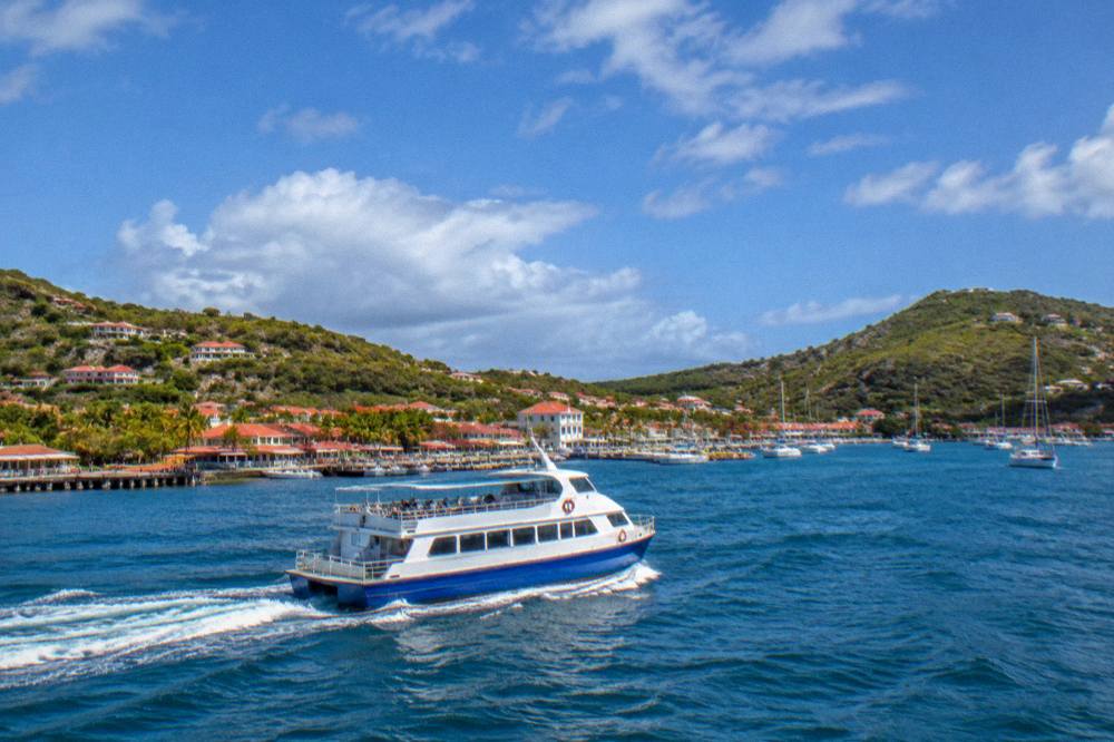 A ferry boat crossing open blue water between St Martin and St Barts in morning light