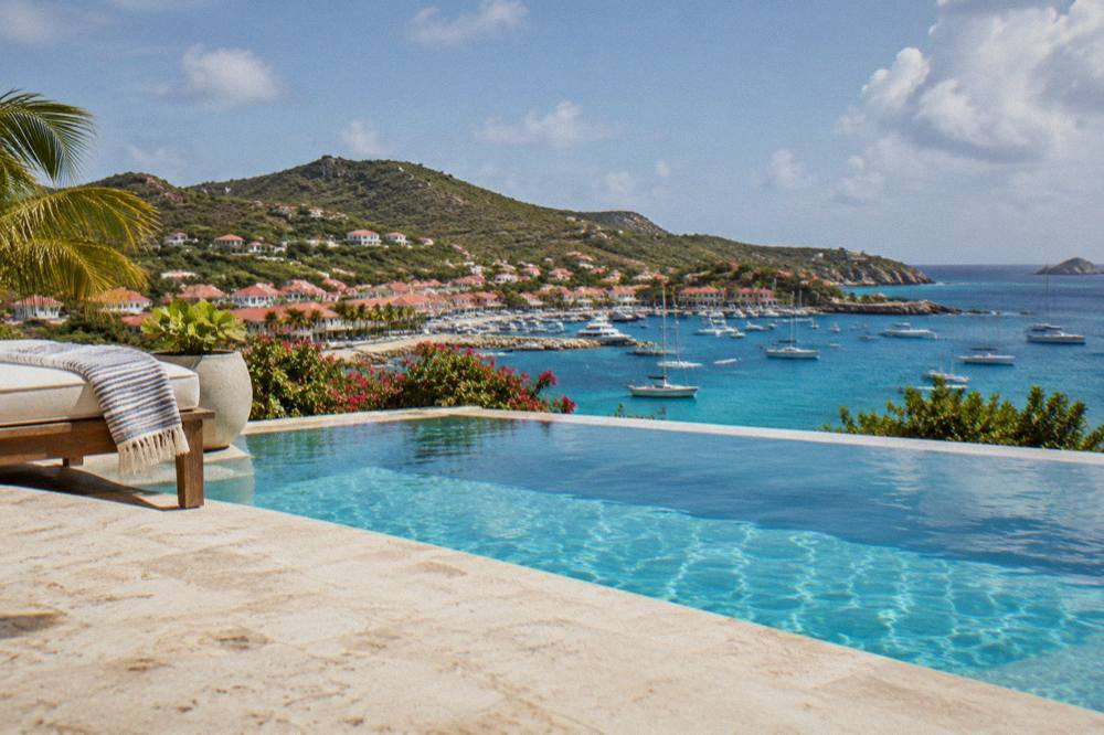 A private villa pool on a terrace with a wide view over the sea