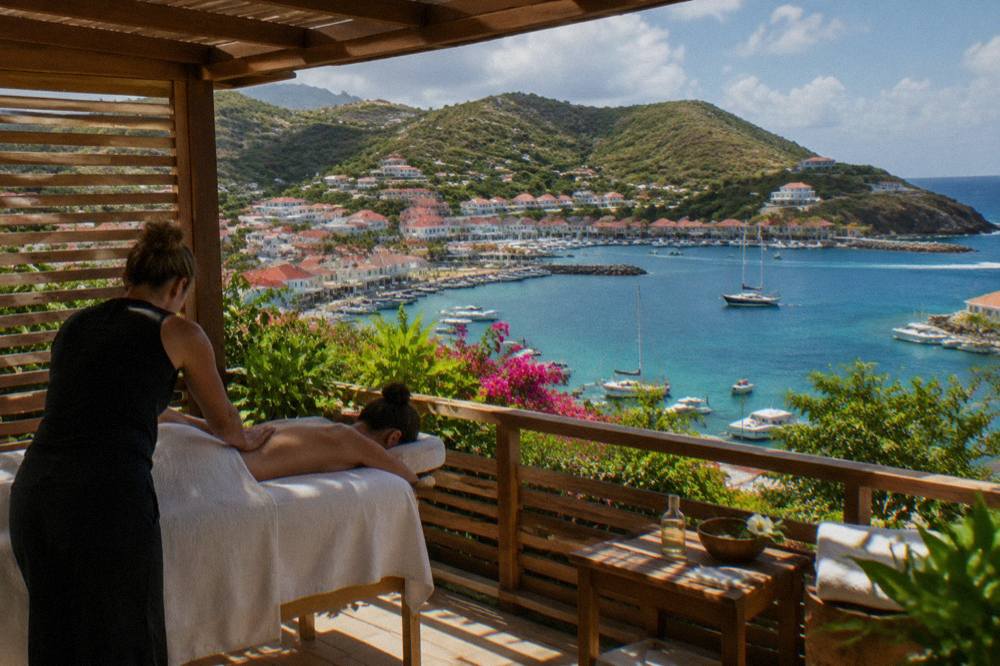 An outdoor massage pavilion with wooden slats and a view of green hills