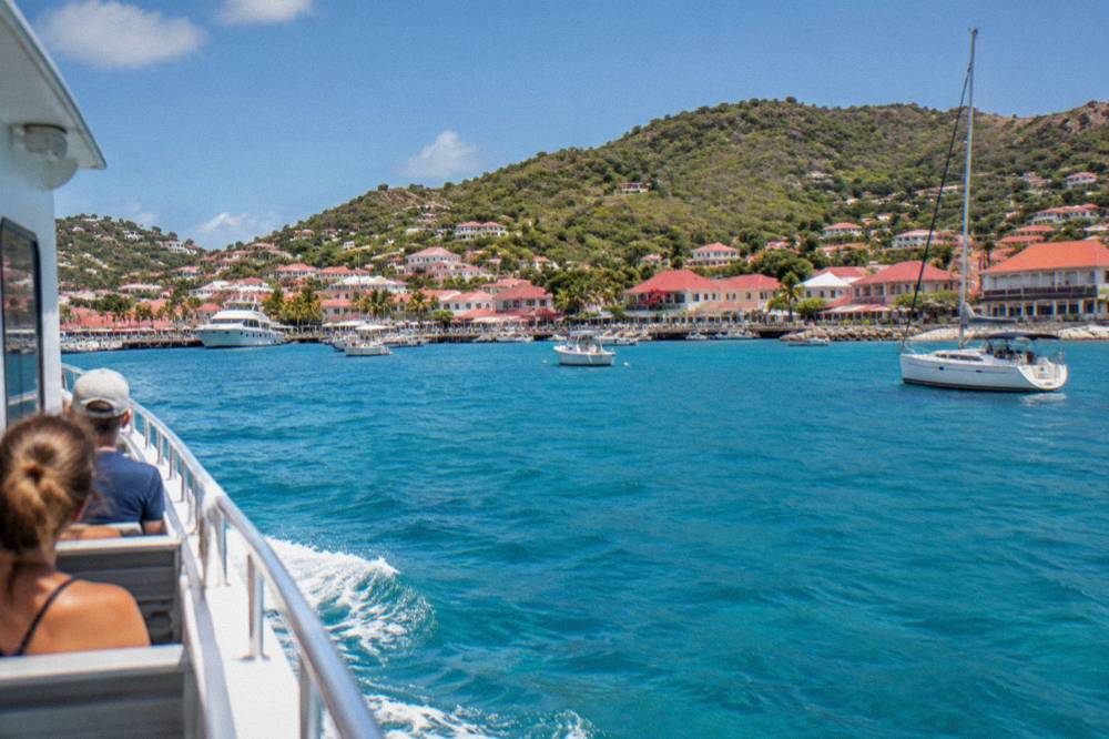 Ferry boat approaching the harbor at Gustavia in St Barts under a clear sky
