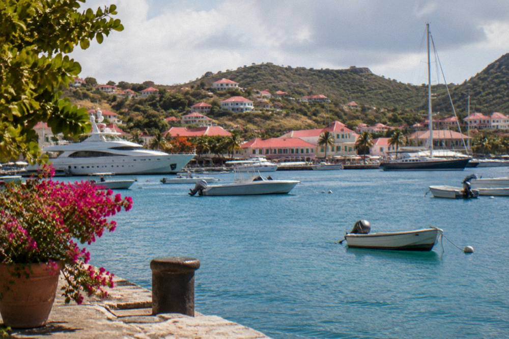 Evening light over a Caribbean harbor with yachts and low hills