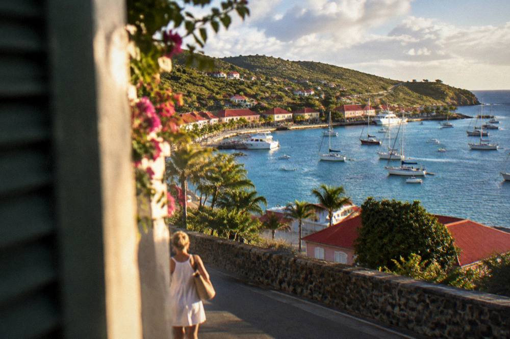 A narrow winding road with sea views between hills on the island of St Barts