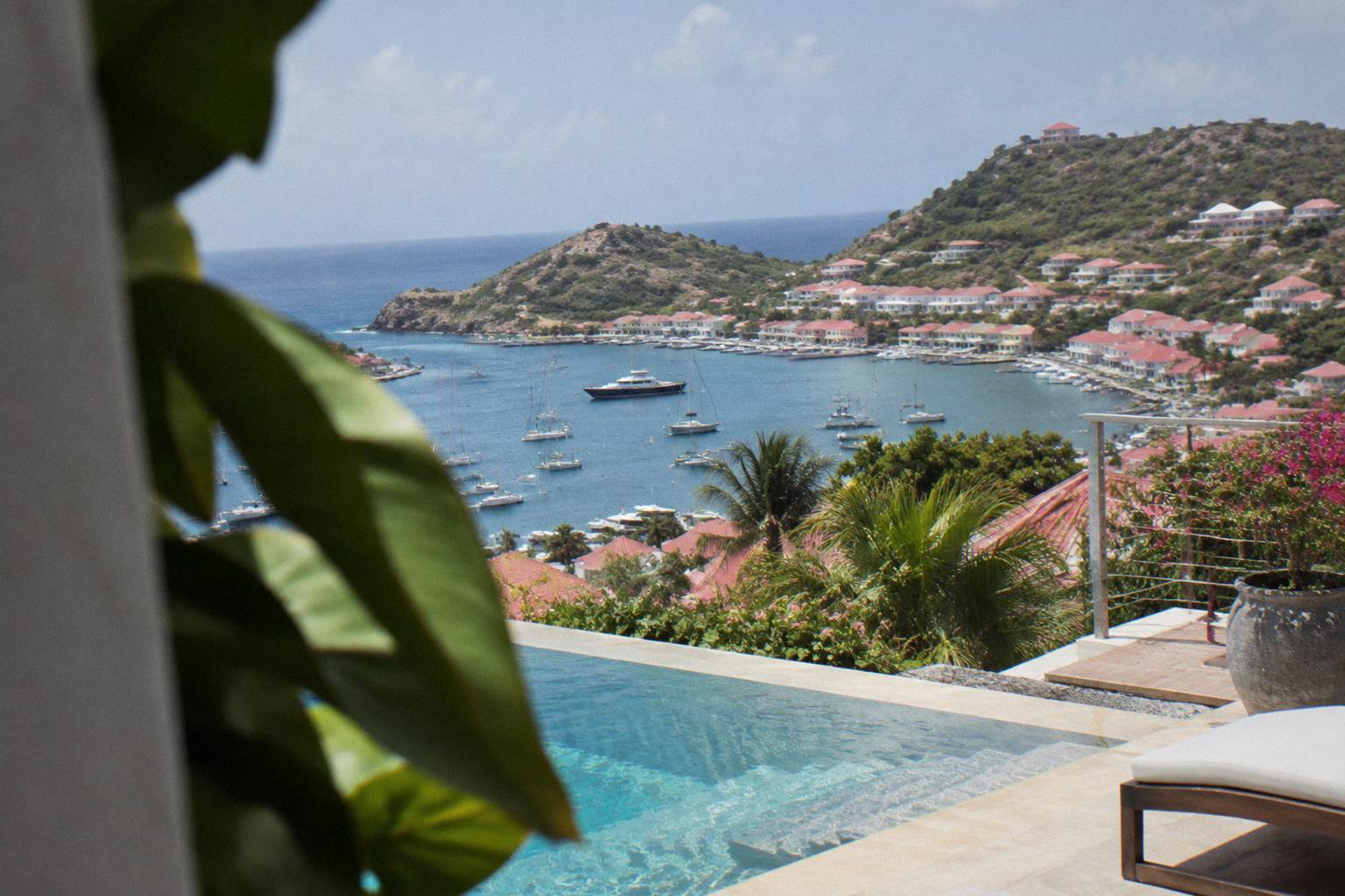 Hillside villa terrace with a pool and sea view, empty
