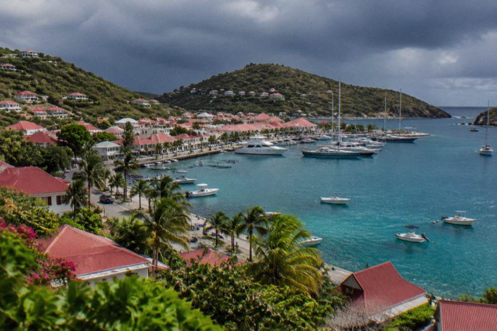 Dark storm clouds gathering over the hills of a Caribbean island