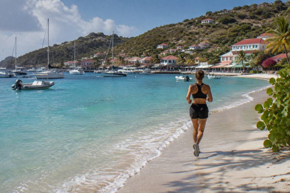 Clear turquoise shallow water over pale sand at a St Barts beach
