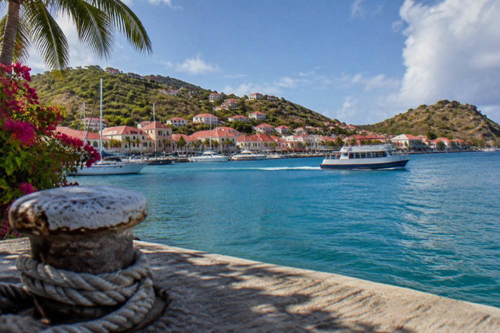 A small ferry boat crossing open water between Caribbean islands
