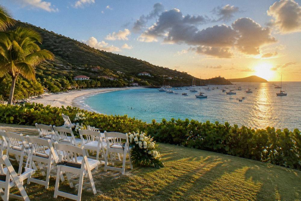 White chairs arranged on a lawn above the sea for an outdoor ceremony