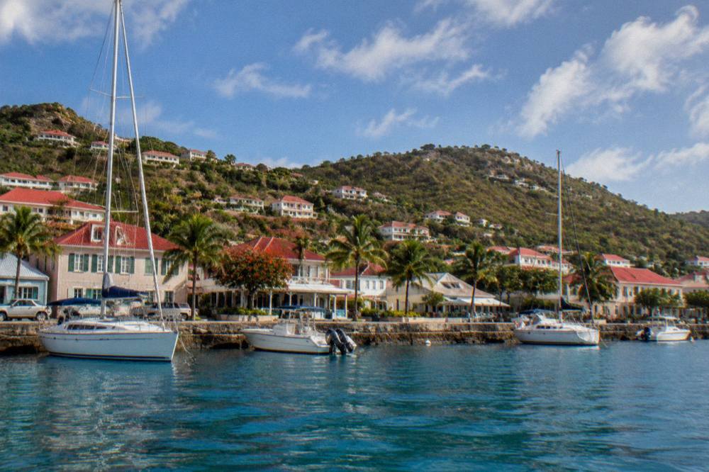 The waterfront of Gustavia seen from the water with quay walls and moored boats