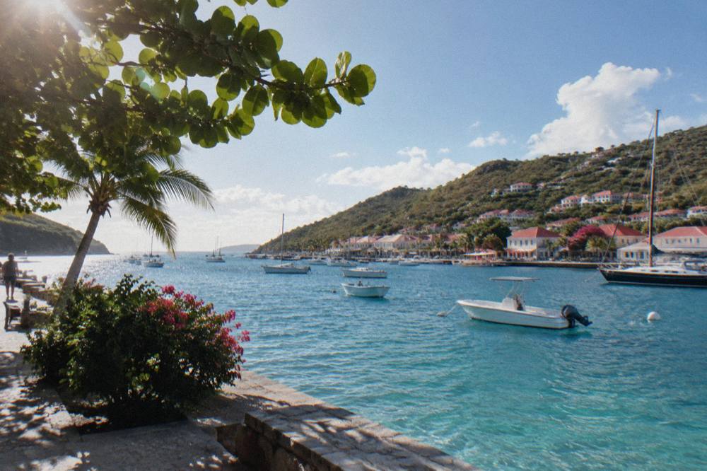 Turquoise channel of open sea between two green Caribbean islands