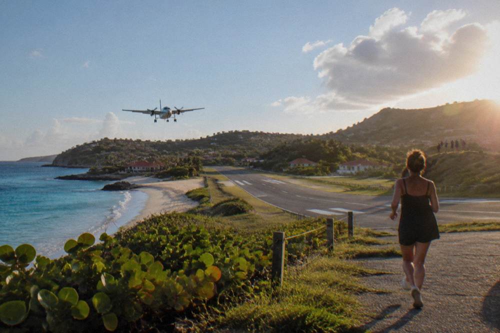 Small turboprop airplane on a short runway beside a beach