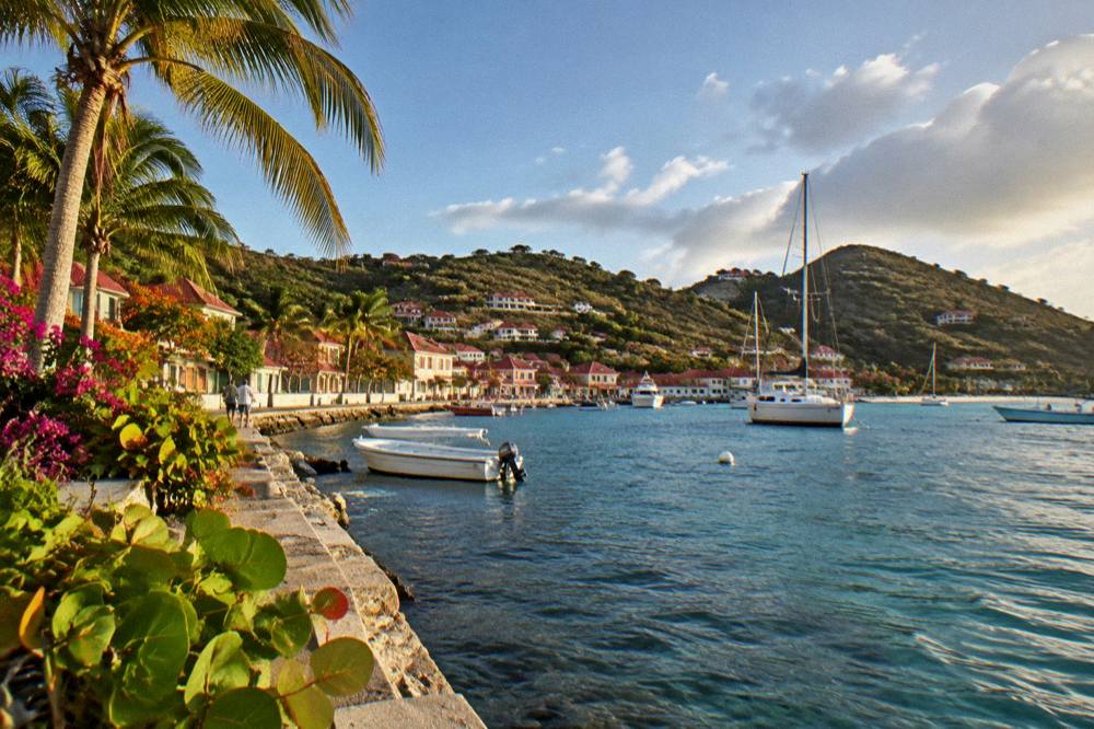 Hillside villas overlooking a bay with a pale sandy beach