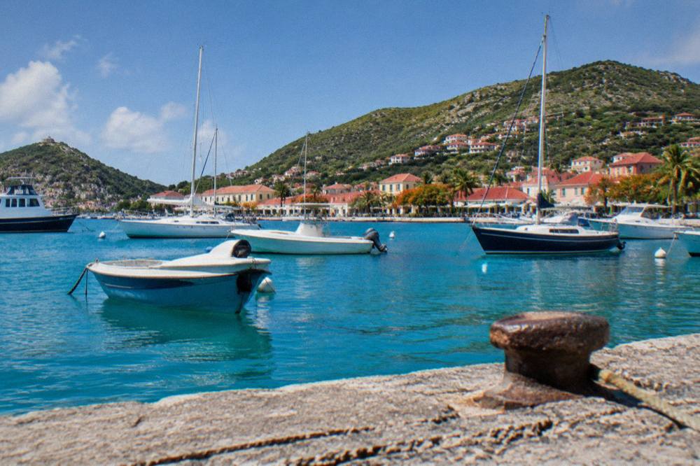 Fishing and sailing boats moored in a small Caribbean harbour at midday