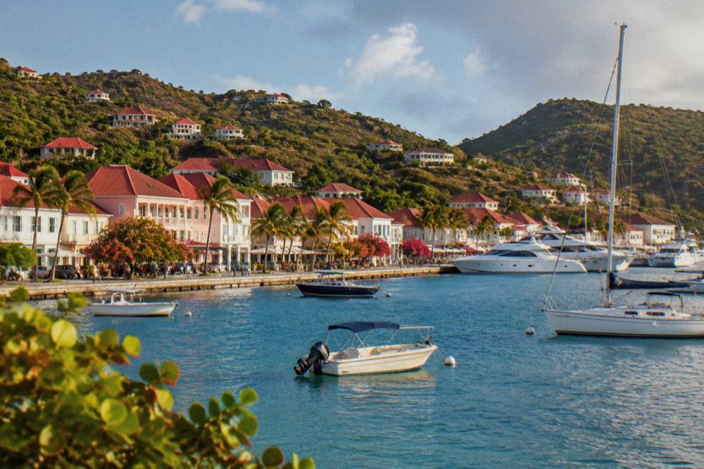Pastel buildings and red roofs along the waterfront street in Gustavia, St Barts