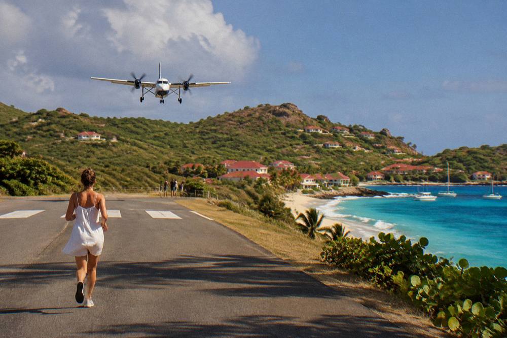 A small turboprop aircraft on a short runway between a hill and a beach