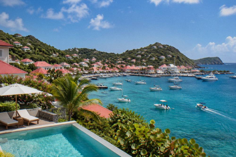 A hillside villa with a pool overlooking the sea and neighbouring headlands