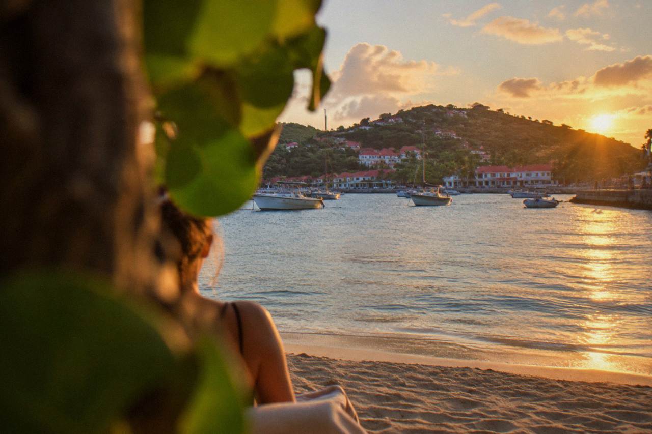 Sunrise light over the hills and turquoise water of a Caribbean island coastline