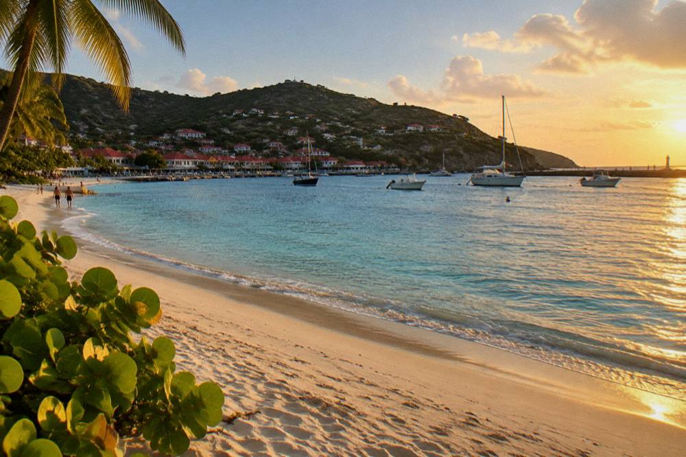 A quiet Caribbean beach at dusk with soft light on the sand and sea